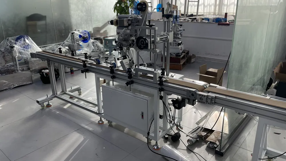 Inline Tape Applicator with Automatic Cutting and Discharge — Taping station on the conveyor line