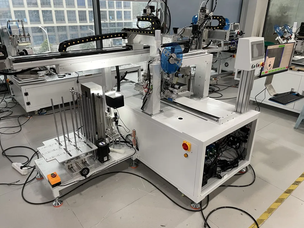 Vision-Aligned Tape Applicator with Auto Loading & Unloading — Gantry tape head and stack loading station