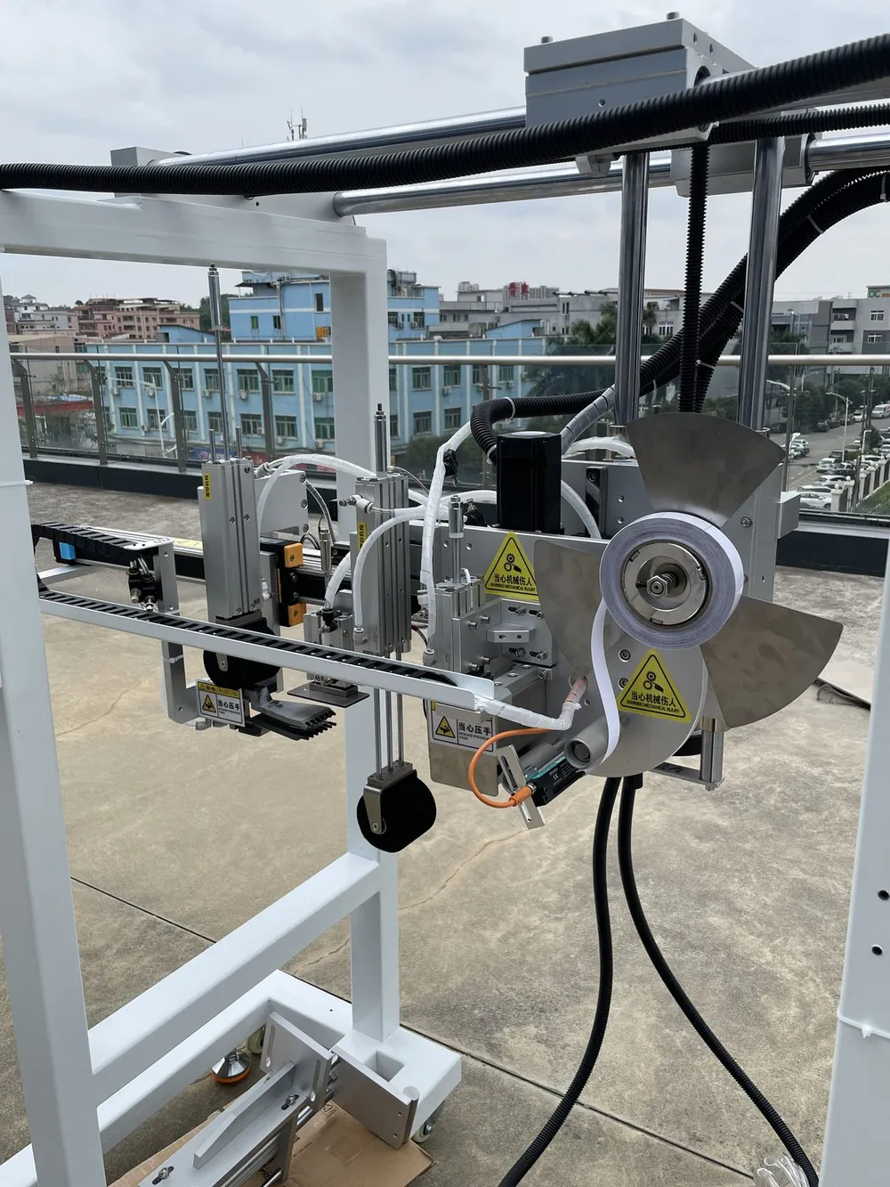 Gantry-Mounted Tape Applicator Head — Tape head on the gantry axis