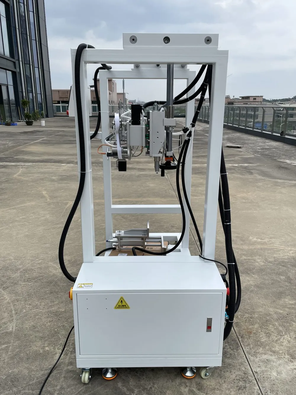 Gantry-Mounted Tape Applicator Head — Front view with control box