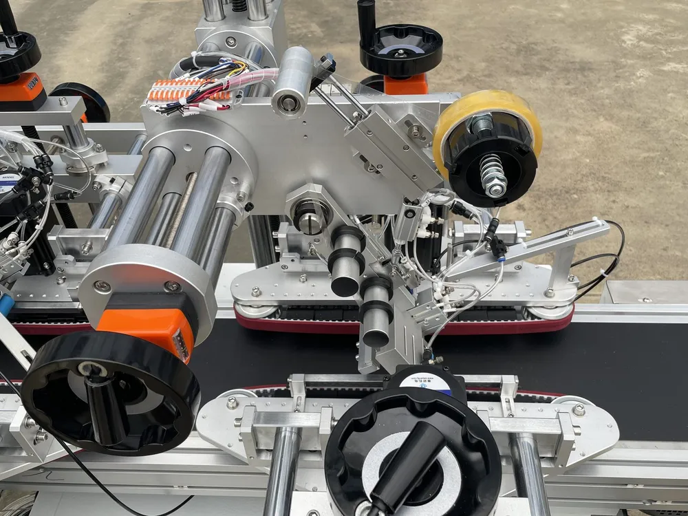 Clamping-Belt Dual-Head Tape Applicator — Tape heads on their columns, with handwheels and position counters