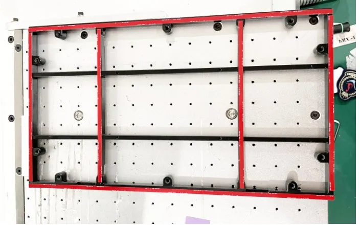 Floor-Standing Rotary-Head Tape Applicator — Frame-shaped workpiece on the vacuum table with tape strips applied horizontally and vertically