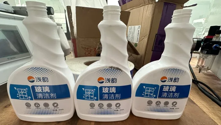 Semi-Automatic Roll-On + Rotary Multi-Face Labeling Machine — Trigger spray bottles (shaped bottles) with labels