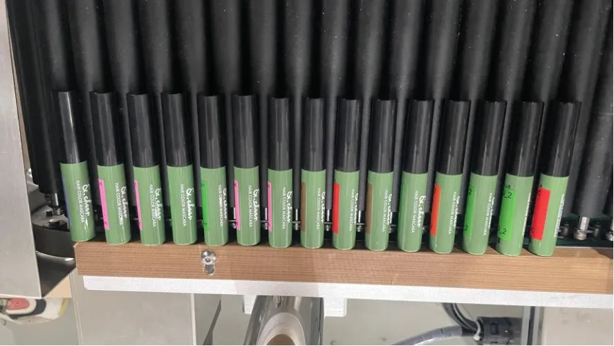 Automatic Horizontal Round Bottle Labeling Machine — Lipstick tubes and other slim tubes with labels