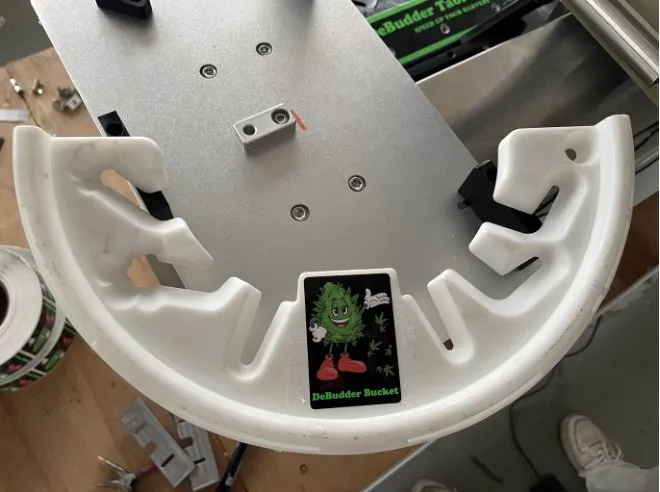Semi-Automatic Front-and-Back Roll-On Labeling Machine — Product positioned in a fixture for labeling
